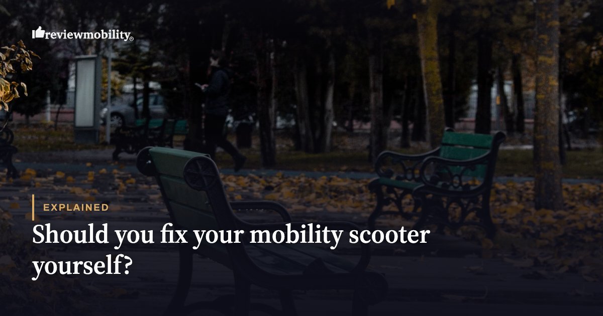 Hero image for a Review Mobility article: dark park scene with empty benches and overlay text reading 'Explained' and 'Should you fix your mobility scooter yourself?'