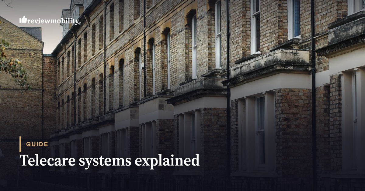 Telecare systems explained Row of brick townhouses on a city street with a 'Guide: Telecare systems explained' title and the Review Mobility logo in the top-left.