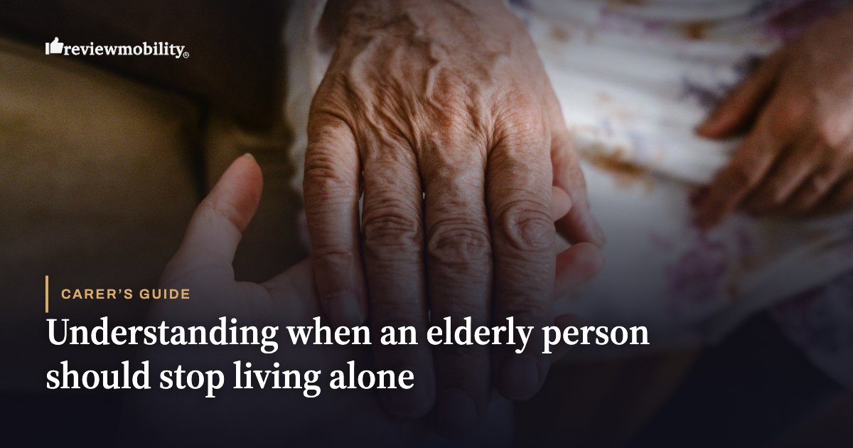 Understanding when an elderly person should stop living alone Close-up of an elderly hand being held by a younger hand, on a cover about caregiving for seniors living alone.